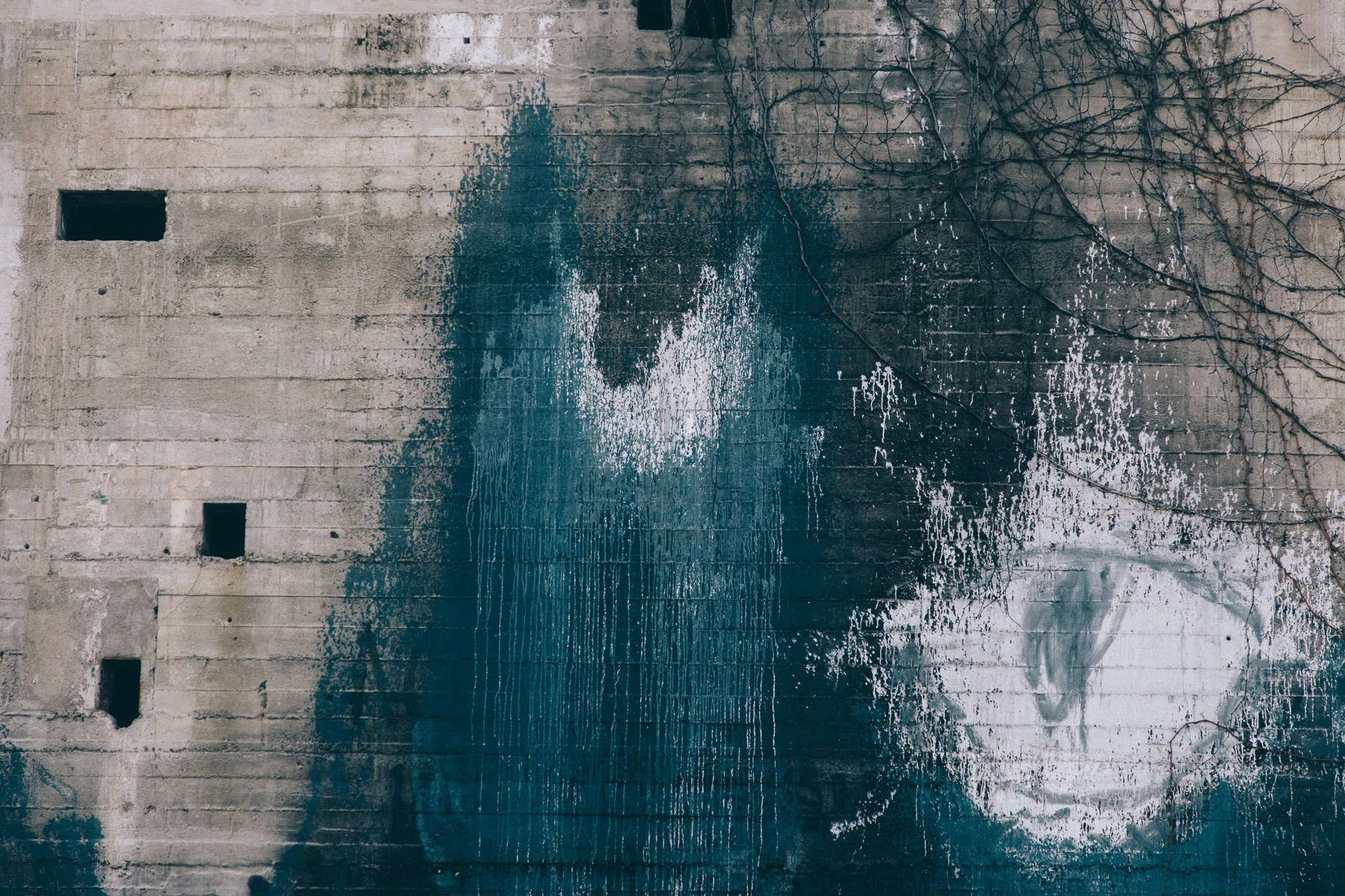 Dark stains spreading across a concrete wall